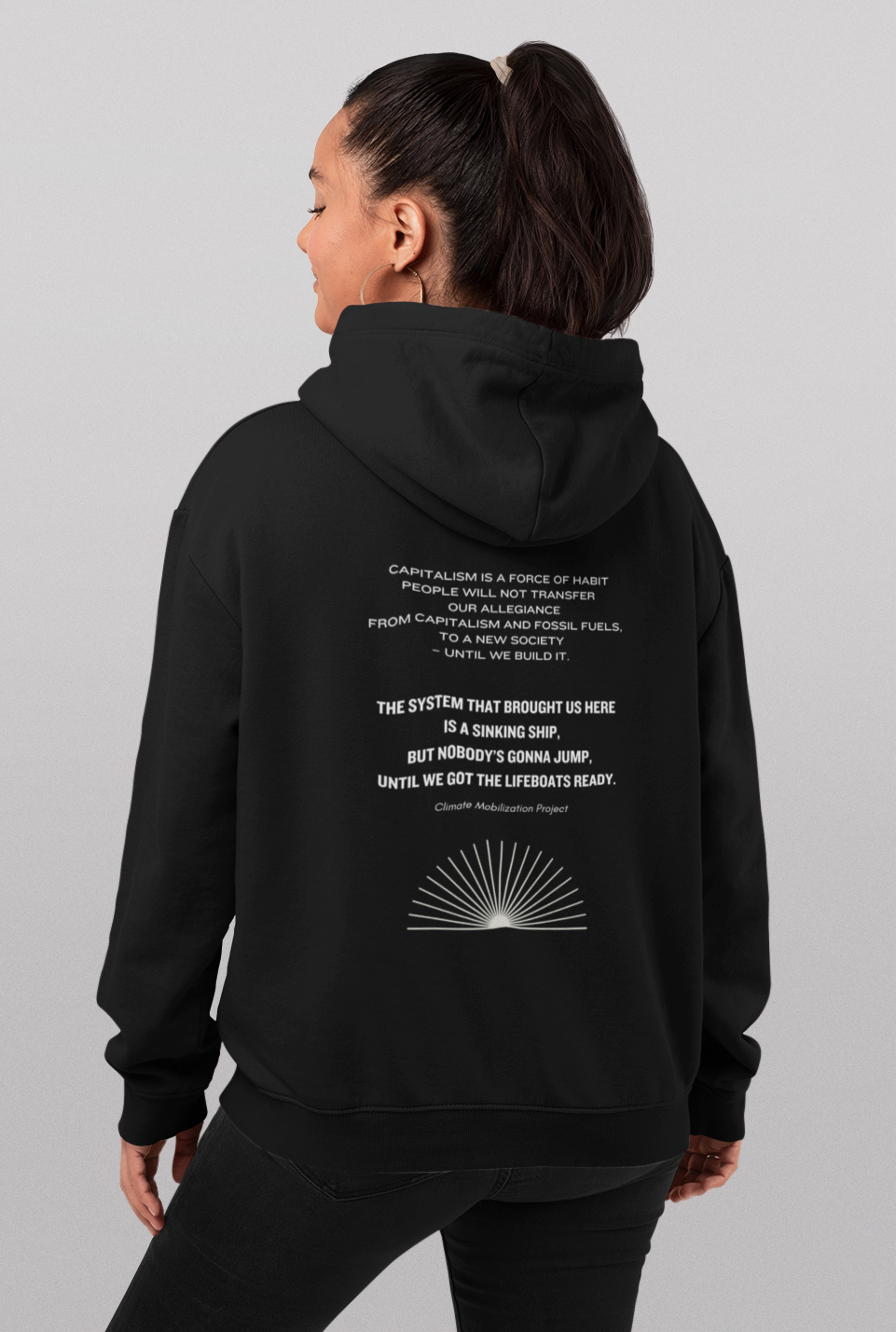 Person wearing the Climate Survival hoodie, turned away from the camera to show the back.