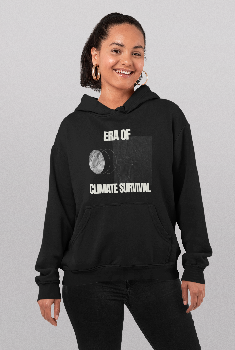 Person wearing the black Climate Survival hoodie, which says "ERA OF CLIMATE SURVIVAL" with some semi-abstract imagery on the front.